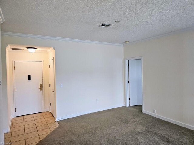 unfurnished room featuring a textured ceiling, ornamental molding, and light carpet