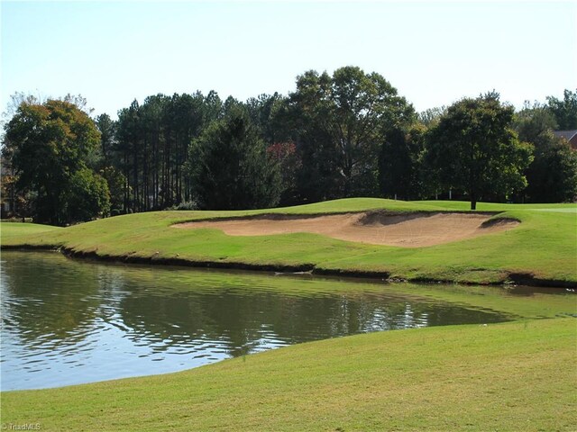 view of property's community featuring a water view and a lawn