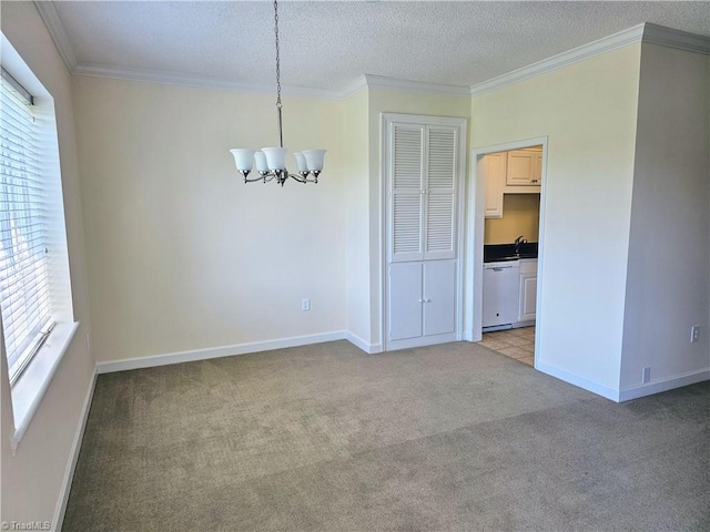 spare room with crown molding, a textured ceiling, a chandelier, and light colored carpet