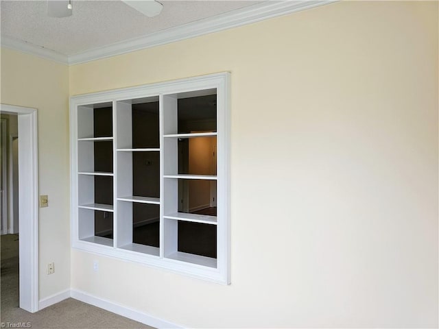 interior space featuring carpet floors, ornamental molding, and baseboards