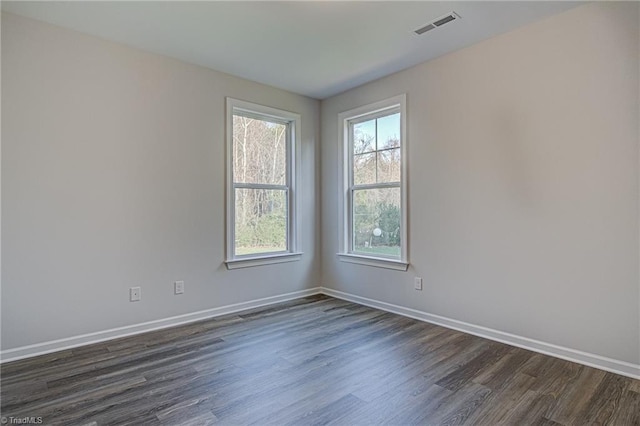 spare room with dark hardwood / wood-style floors