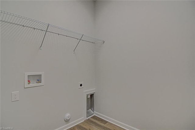 washroom featuring hookup for a washing machine, hardwood / wood-style floors, hookup for a gas dryer, and hookup for an electric dryer