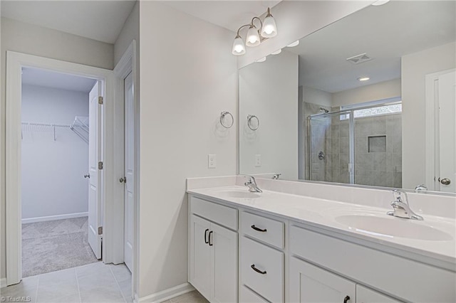 bathroom featuring vanity, walk in shower, and tile patterned flooring