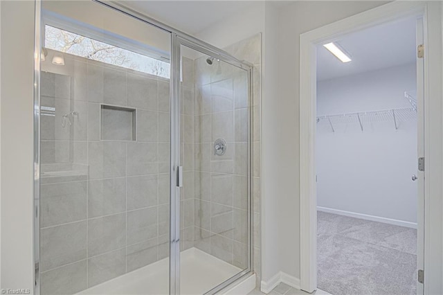 bathroom with a shower with door