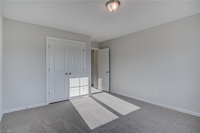 unfurnished bedroom featuring carpet floors and a closet