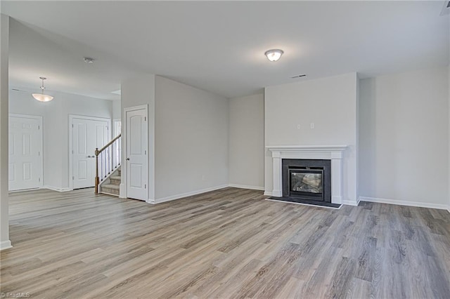 unfurnished living room featuring light hardwood / wood-style floors