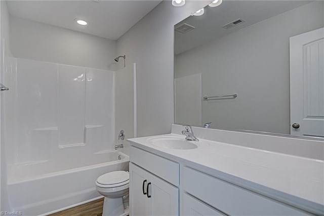 full bathroom with toilet, tub / shower combination, vanity, and hardwood / wood-style floors