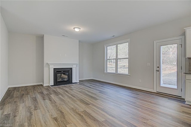 unfurnished living room featuring light hardwood / wood-style floors