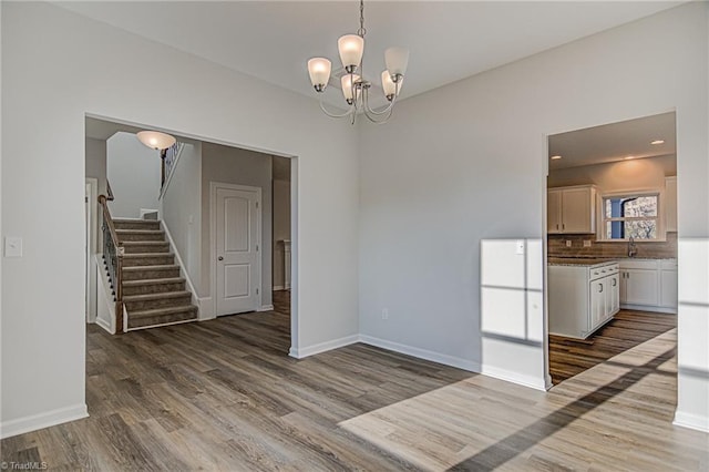 interior space featuring dark hardwood / wood-style flooring and an inviting chandelier