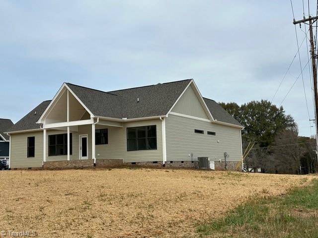 back of house featuring central AC unit