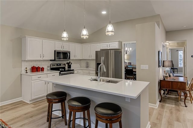 kitchen with sink, white cabinetry, decorative backsplash, and stainless steel appliances