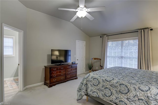 carpeted bedroom with a closet, ceiling fan, vaulted ceiling, and multiple windows