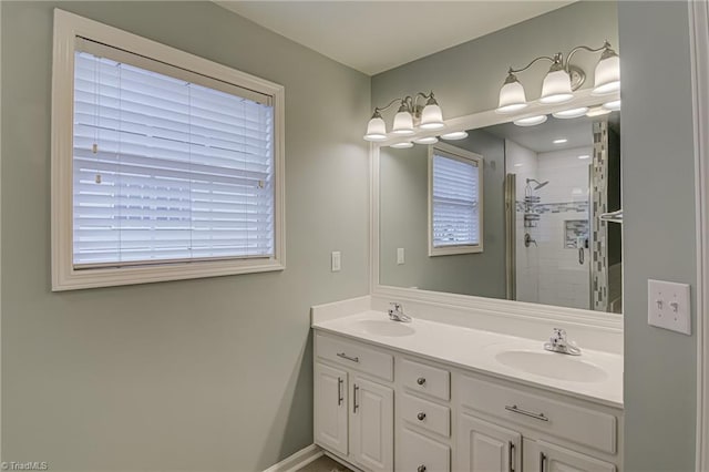 bathroom with vanity, a shower with shower door, and plenty of natural light