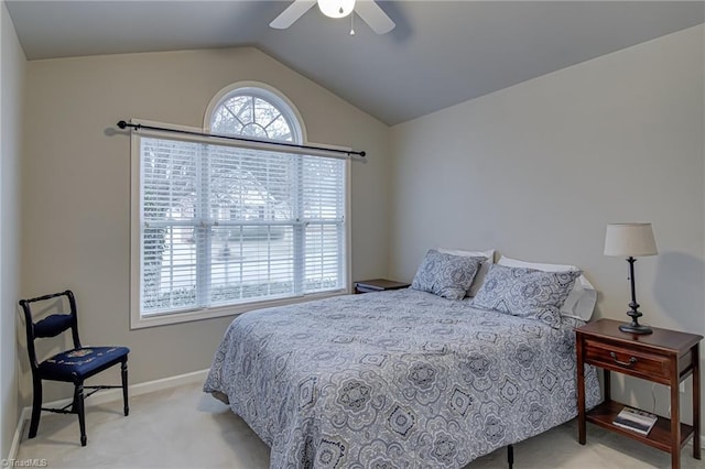 carpeted bedroom featuring ceiling fan and vaulted ceiling