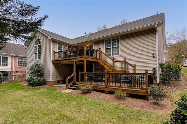 rear view of property with a lawn and a wooden deck