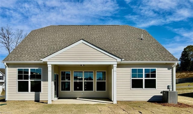 rear view of house featuring a yard, central AC, and a patio