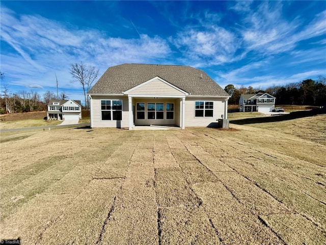 rear view of property with a lawn