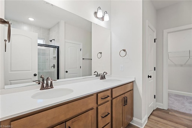 bathroom with vanity, hardwood / wood-style floors, and a shower with shower door