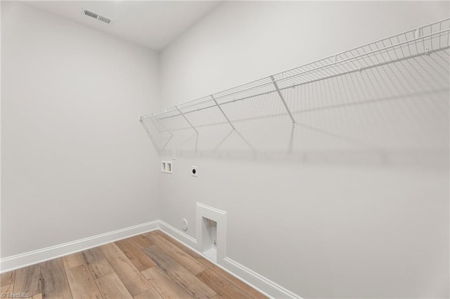 laundry area featuring electric dryer hookup, washer hookup, wood-type flooring, and gas dryer hookup