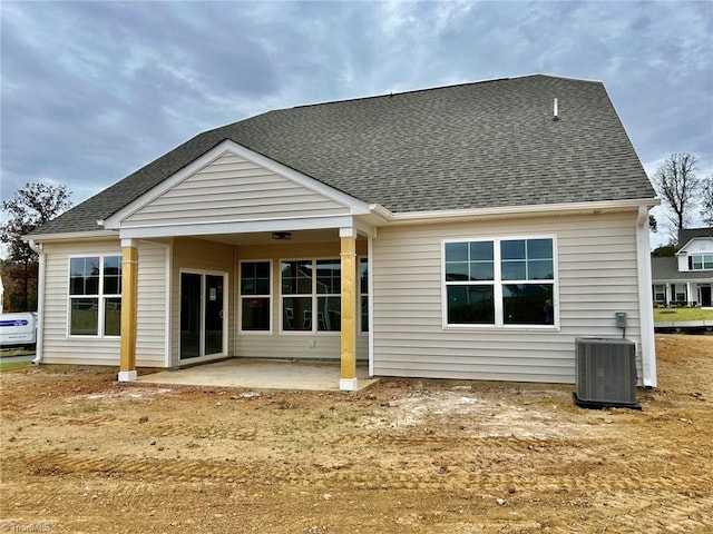 rear view of house with central AC and a patio