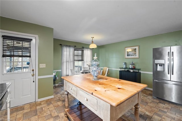 dining area with stone tile flooring and baseboards