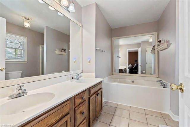 bathroom featuring a sink, double vanity, a bath, and tile patterned floors