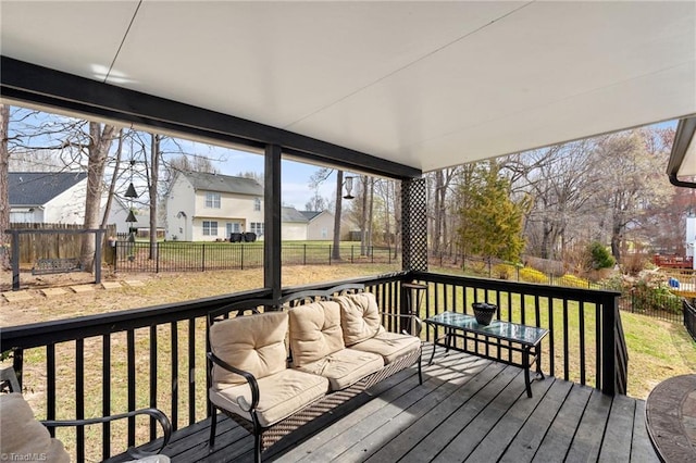 deck featuring outdoor lounge area, a fenced backyard, and a lawn