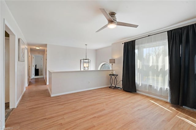 unfurnished room featuring ceiling fan, a healthy amount of sunlight, and light wood-style flooring