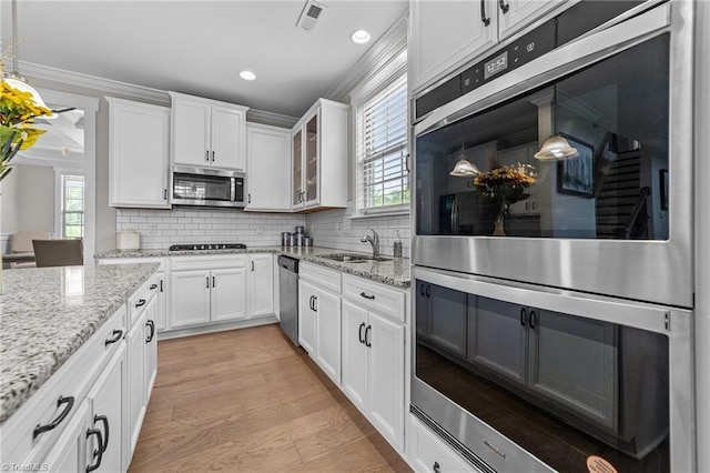 8018 Hacker Dr, Stokesdale, NC 27327 - kitchen featuring appliances with stainless steel finishes, a sink, white cabinets, glass insert cabinets, and recessed lighting