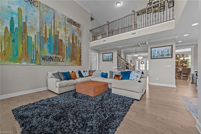 8018 Hacker Dr, Stokesdale, NC 27327 - living area with a chandelier, stairway, baseboards, crown molding, and wood finished floors