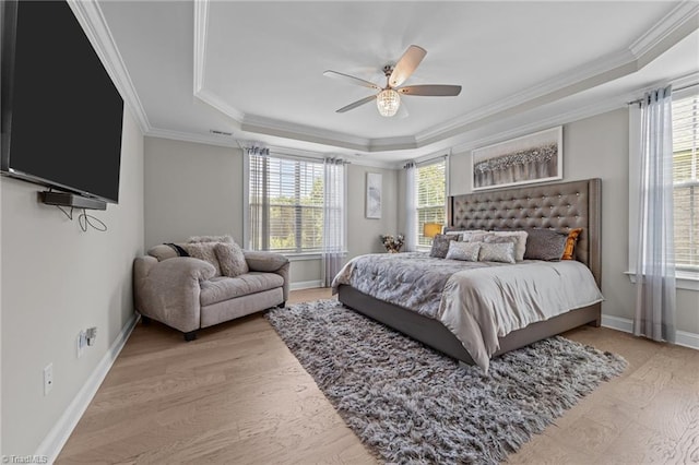 8018 Hacker Dr, Stokesdale, NC 27327 - bedroom with a tray ceiling, ornamental molding, light wood finished floors, ceiling fan, and baseboards