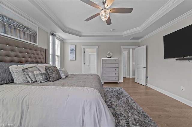 8018 Hacker Dr, Stokesdale, NC 27327 - bedroom featuring wood finished floors, a raised ceiling, baseboards, ornamental molding, and a ceiling fan