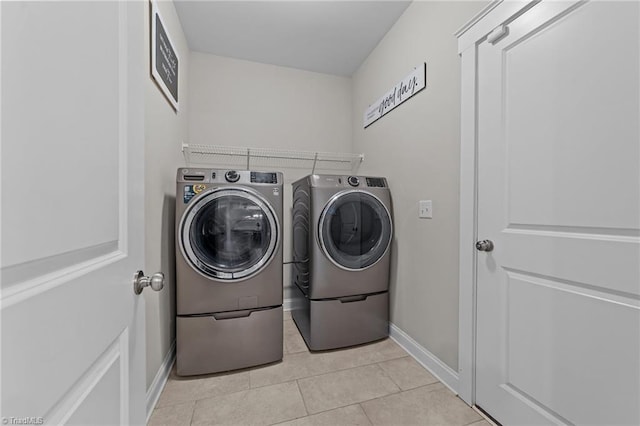 8018 Hacker Dr, Stokesdale, NC 27327 - washroom featuring washer and dryer, baseboards, and light tile patterned floors