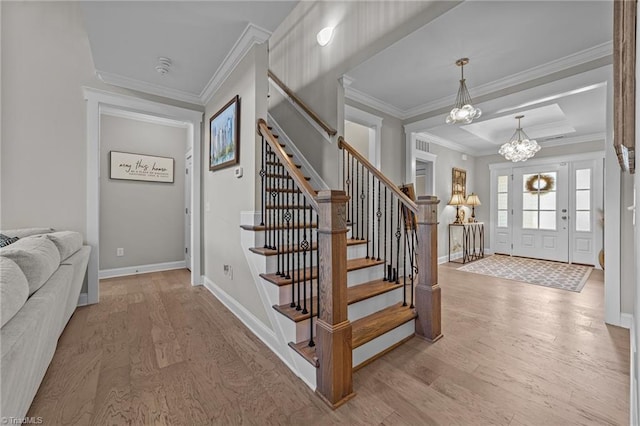 8018 Hacker Dr, Stokesdale, NC 27327 - stairway featuring wood finished floors, a chandelier, ornamental molding, and baseboards