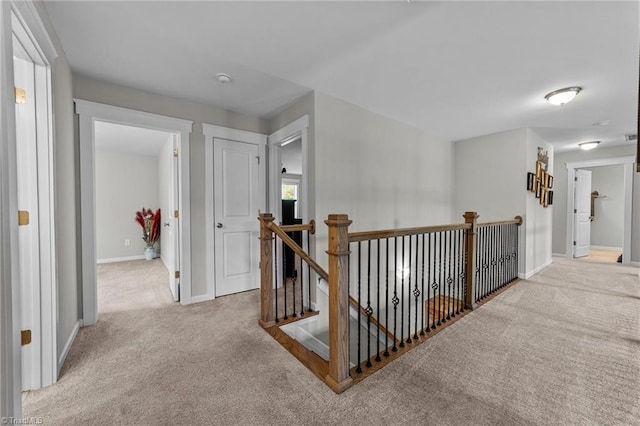 8018 Hacker Dr, Stokesdale, NC 27327 - hall featuring carpet floors, an upstairs landing, and baseboards