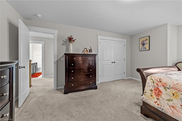 8018 Hacker Dr, Stokesdale, NC 27327 - bedroom featuring light carpet, baseboards, and a closet