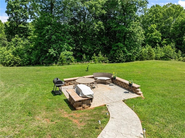 8018 Hacker Dr, Stokesdale, NC 27327 - view of green lawn featuring an outdoor fire pit and a patio area