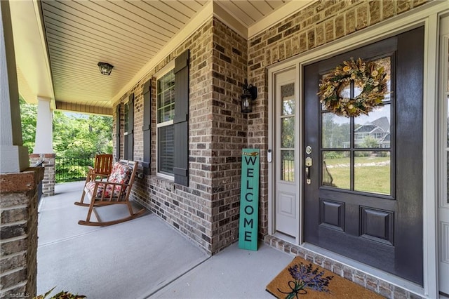 8018 Hacker Dr, Stokesdale, NC 27327 - entrance to property with a porch and brick siding