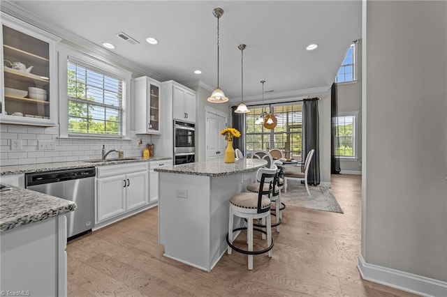 8018 Hacker Dr, Stokesdale, NC 27327 - kitchen featuring appliances with stainless steel finishes, a sink, a center island, baseboards, and ornamental molding