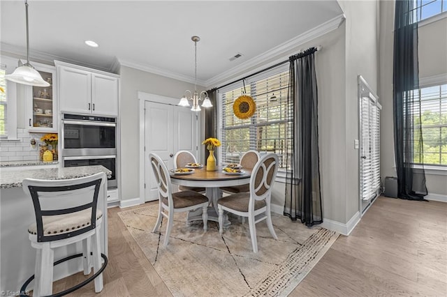 8018 Hacker Dr, Stokesdale, NC 27327 - dining room featuring a chandelier, baseboards, light wood-style flooring, ornamental molding, and recessed lighting