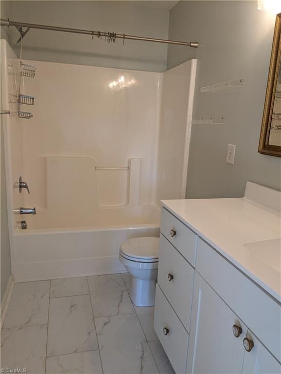 bathroom with  shower combination, marble finish floor, vanity, and toilet