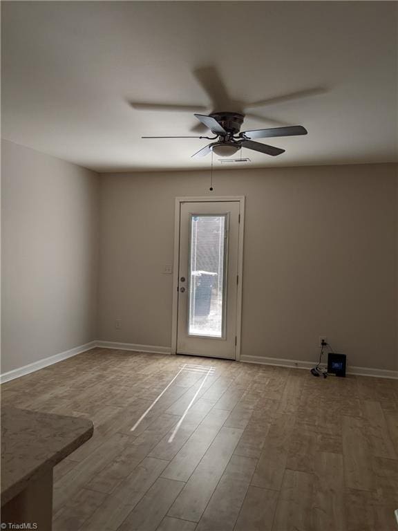 spare room with wood finished floors and baseboards