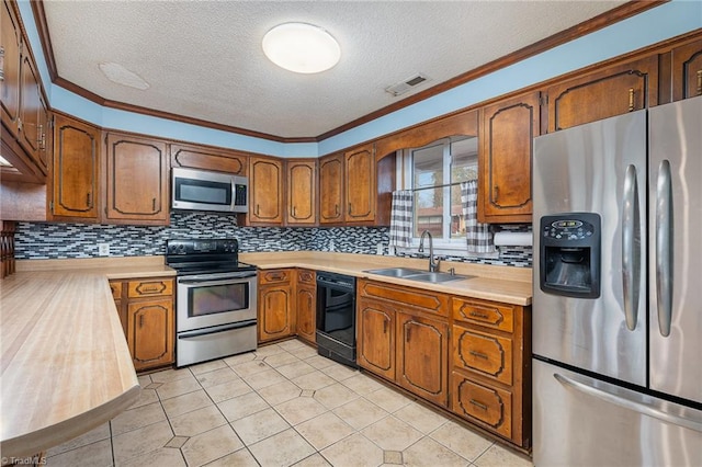 kitchen with crown molding, sink, decorative backsplash, a textured ceiling, and appliances with stainless steel finishes