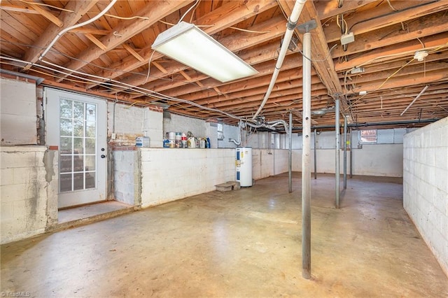 basement featuring electric panel and electric water heater