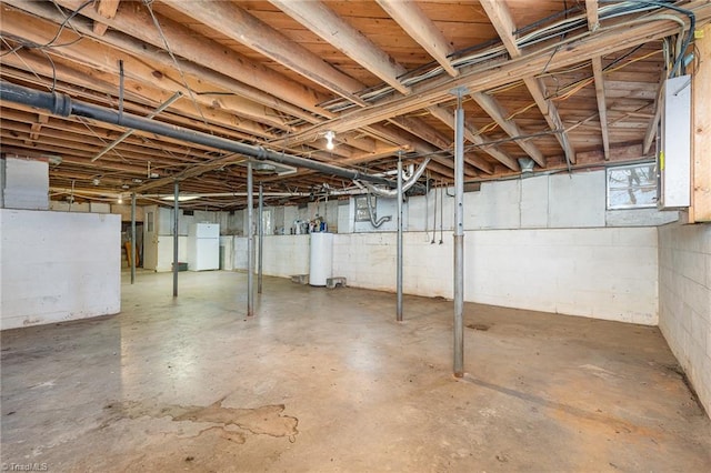 basement with white fridge and gas water heater