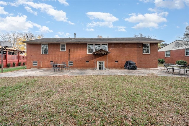 back of property featuring a yard and a patio area