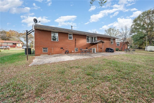 rear view of house featuring a yard and a patio