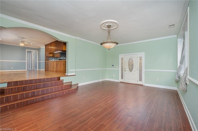 unfurnished living room with dark hardwood / wood-style floors, ceiling fan, and ornamental molding