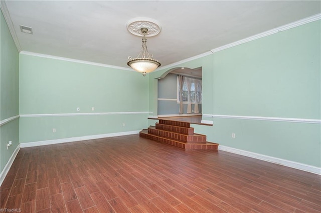 unfurnished living room with dark hardwood / wood-style floors and crown molding