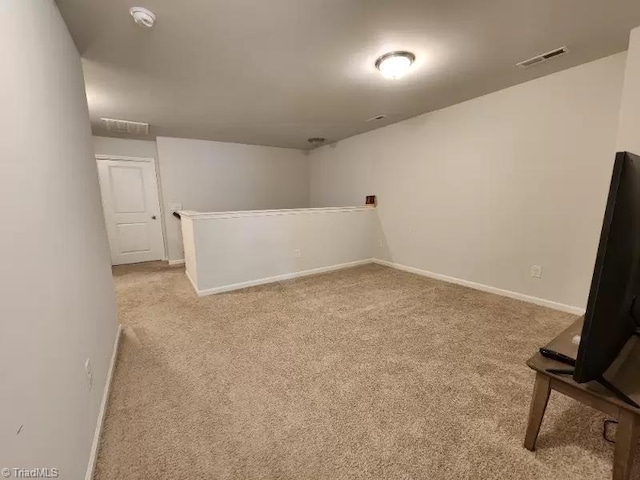 basement featuring light colored carpet